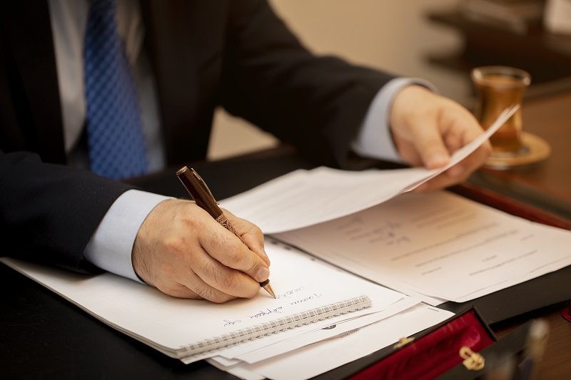 Businessman signing important contract papers. High quality photo